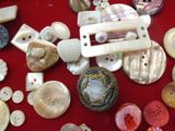 a lot of buttons and buttons on a red table