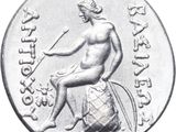 an image of a silver coin with a woman sitting on top of a barrel