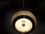 a light that is hanging from a ceiling in a dark room