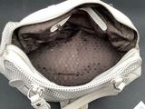 a white purse with a zipper on the inside of it
