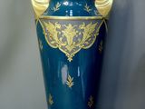 a large blue vase with gold decoration on it