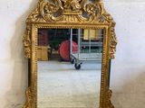 a mirror that is sitting on the floor in front of a wall