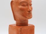 an image of a clay sculpture of a man ' s head on a block
