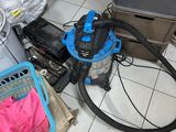 a vacuum and other items on the floor in a room