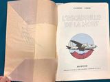 a person holding a book with a picture of a plane