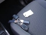 a picture of a car seat with a bunch of keys attached to it