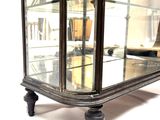 a glass display case with a mirror on top of it