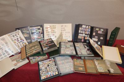 a lot of stamps and folders sitting on a table
