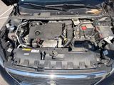 the engine of a car with its hood open in a parking lot