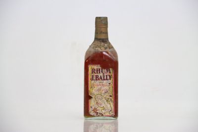 a bottle of red wine sitting on a white surface