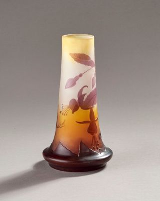 a glass vase with a design on it on a table