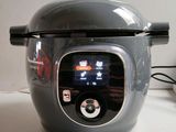 someone is using a digital pressure cooker to cook food