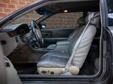 the interior of a car with the door open and the driver ' s seat up