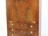 a wooden chest of drawers with brass hardware on it