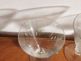 two empty wine glasses sitting on a wooden table