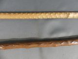 two different types of canes on display in a glass case