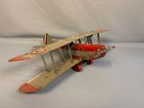 a toy airplane that is sitting on a white surface