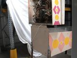 an image of a machine in a warehouse with a tarp on the back