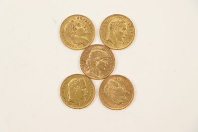 four different types of gold coins are arranged on a white surface