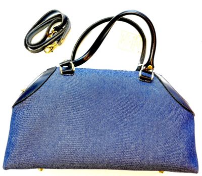 denim handbag with black leather handles and gold hardware