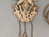 a clock that is hanging on the wall next to a pair of scissors