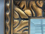 a picture of a mirror that is on the wall