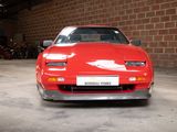 an image of a red sports car parked in a garage