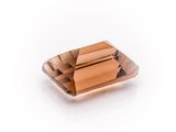 an image of a square shaped brown crystal on a white surface