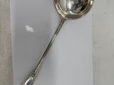 a spoon that is sitting on a piece of paper