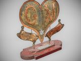 a sculpture of a heart shaped object on a stand