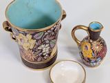 two vases and a small bowl on the table