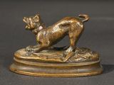 bronze statue of a dog on a pedestal on a black surface
