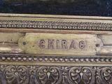 a close up of a gold plate with a name plate