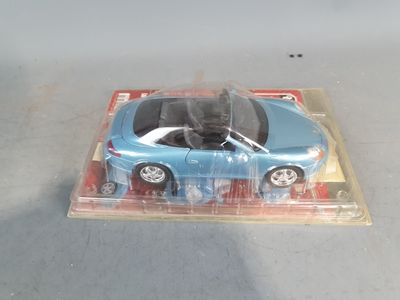 a blue toy car in a clear plastic box