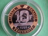 a coin in a plastic container on a green surface