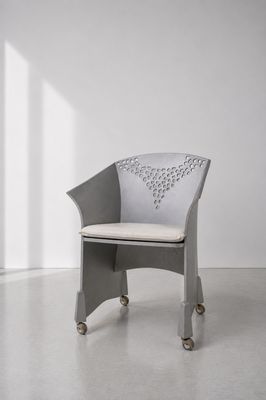 une image représentant une chaise à roulettes dans une pièce blanche