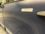 a blue car with a sticker on the side of it