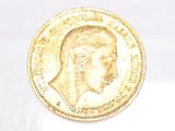 an image of a gold coin with a profile of a man on it