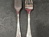 two forks and a knife sitting on a table