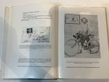 an open book with a drawing of a man on a bicycle