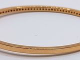 an image of a close up of a gold bracelet on a white surface