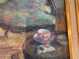 a painting of a chair and a cup on a table