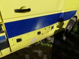 a yellow and blue bus parked in a parking lot