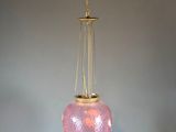 a pink glass lamp hanging from the ceiling