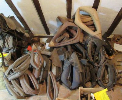 many pairs of shoes and gloves sitting on the floor