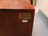 a close up of a wooden box with a name on it