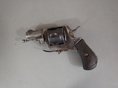 a gun that is on a table with a white background