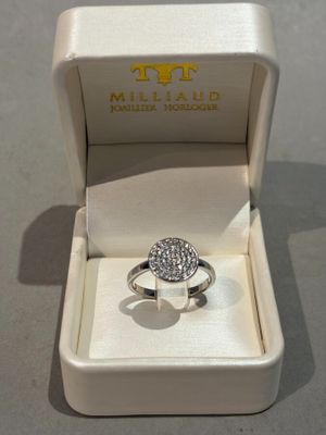 a white box with a ring in it on a table