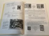 an open book with stamps on it sitting on a table
