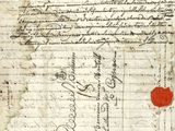 un vieux document sur lequel figurent des inscriptions et un cœur rouge